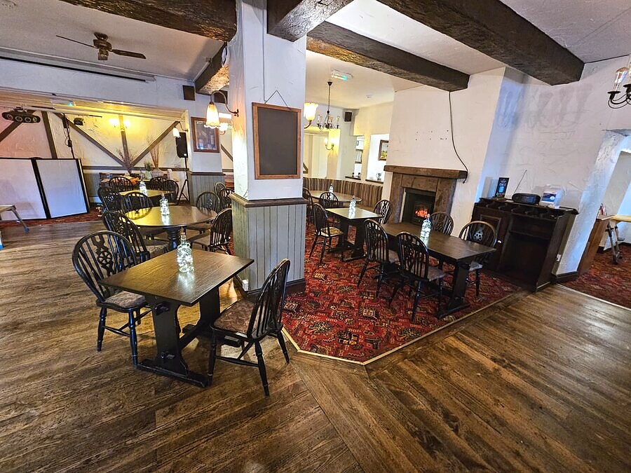 Seating area by the fireplace at The Lockoford